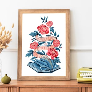 May include: A framed print with a watercolor illustration of a book surrounded by pink flowers and a banner that reads "Surrounded by Endless Stories".