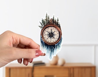 May include: A watercolor illustration of a compass with a forest growing out of it. The compass is surrounded by a blue and white watercolor effect, giving the impression of water.