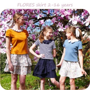 May include: Three girls modelling children's clothing. The outfits include skirts and tops. The skirts are floral print and solid colours. The tops are solid colours and striped. The image includes the text "FLORES skirt 2-16 years" at the top.