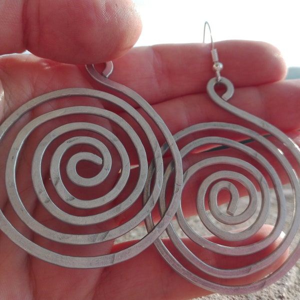 hammered aluminium pendant earrings in the shape of a spiral