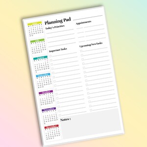 May include: White planning pad with a calendar for June through December. The pad has sections for appointments, priorities, tasks, and notes. The pad is on a gradient background.