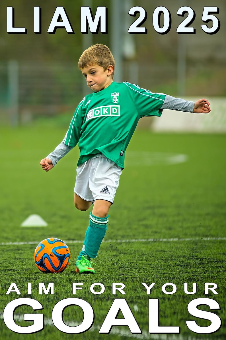 May include: A young soccer player in a green jersey with white shorts and teal socks kicks a soccer ball on a green field. The ball is orange and blue. Text at the top reads "LIAM 2025" and at the bottom "AIM FOR YOUR GOALS."