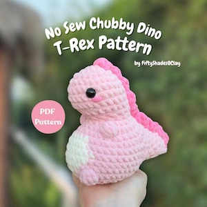 May include: A pink crocheted T-Rex dinosaur with a white belly patch and a pink spine. The text "No Sew Chubby Dino T-Rex Pattern" is displayed above the dinosaur, with "PDF Pattern" in a pink circle on the left.