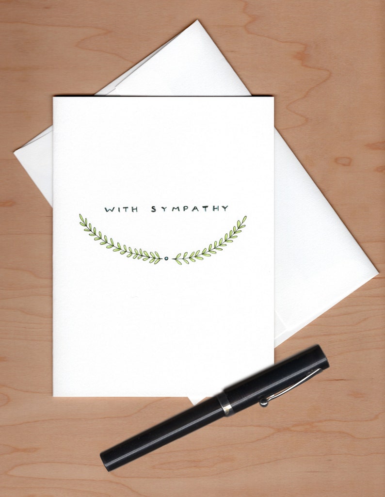 Card with envelope askew behind and a fountain pen below for scale