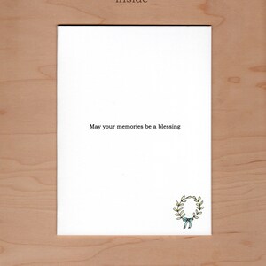 Inside of card:  Message reads "may your memories be a blessing" there is an additional little illustration of a wreath in the bottom right hand corner.