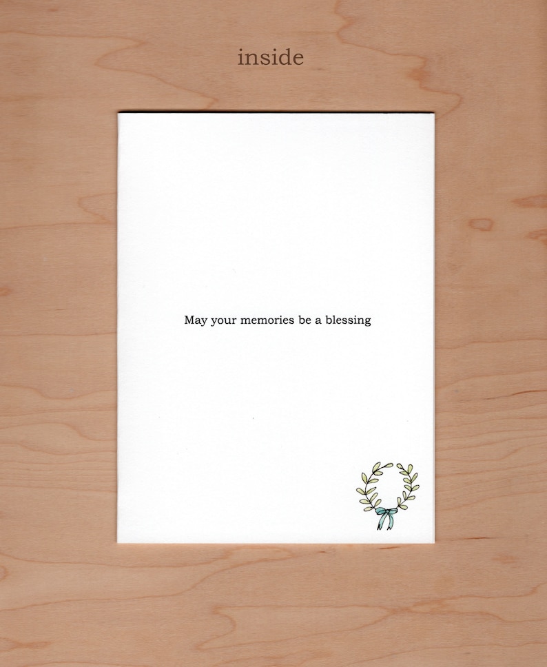 Inside of card:  Message reads "may your memories be a blessing" there is an additional little illustration of a wreath in the bottom right hand corner.