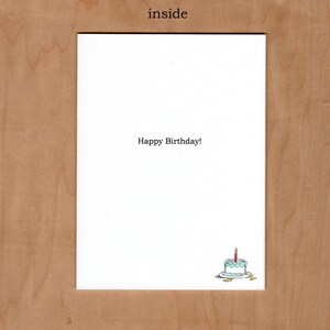 Inside of card reads "Happy Birthday!"  and additional illustration of a blue and white cake with a single red candle is in the bottom right corner of the card