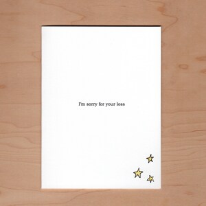 Inside of card: "I'm sorry for your loss".  With additional illustration of three yellow stars in the bottom right corner of card.