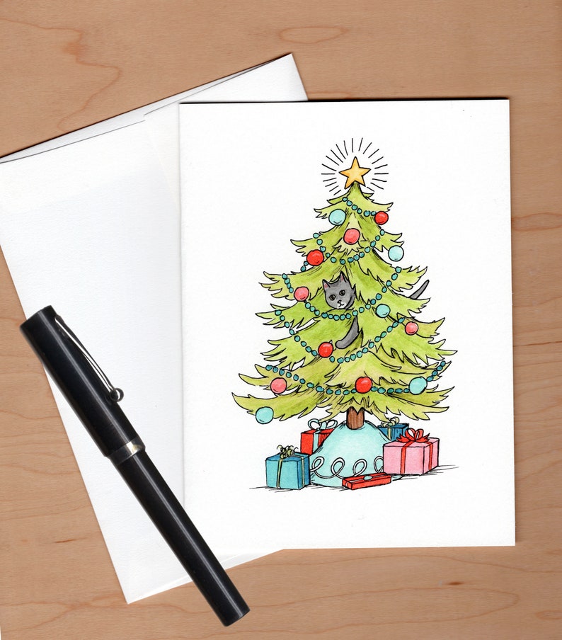 Card with envelope askew behind and a fountain pen to the left for scale