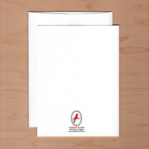 back of card showing logo of a redbird on a branch surrounded by an oval frame centered at the bottom
