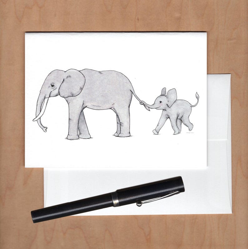 Front of card with envelope behind and black fountain pen below for scale.