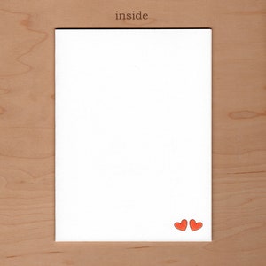 no message inside the card.  Illustration of two small red heart are in the bottom right corner