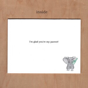Inside of card reads "I'm glad you're my parent!"  there is an additional little illustration in the bottom right corner of a little elephant holding a blue foam finger with the number one on it