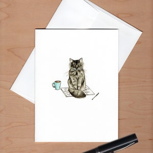 front of card with envelope askew behind and a black fountain pen below for scale