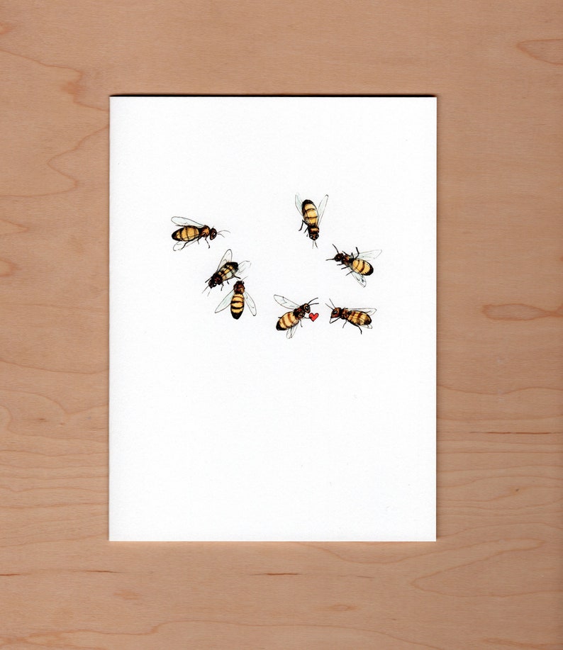 pen and ink and watercolor illustrated honey bees scattered across the front of this card... one bee is giving another a little red heart