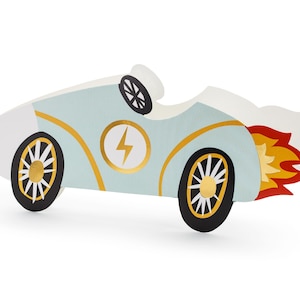 May include: A light blue toy race car with gold accents and a lightning bolt emblem. The car has black wheels with gold details and a white exhaust flame. The car is a fun toy for kids.