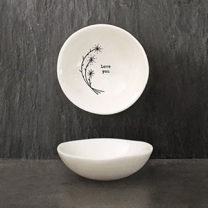 May include: White ceramic dish with a black floral design and the text "Love you".