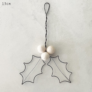 May include: A Christmas holly decoration. The ornament has a black wire frame of holly leaves and three white felt balls. The length of the ornament is 13 cm (5.1 inches) and has a loop for hanging.