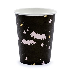 May include: A black paper cup with a white interior, decorated with a pattern of gold and white stars, and light pink bats. The cup is designed for beverages and is suitable for Halloween or themed parties.
