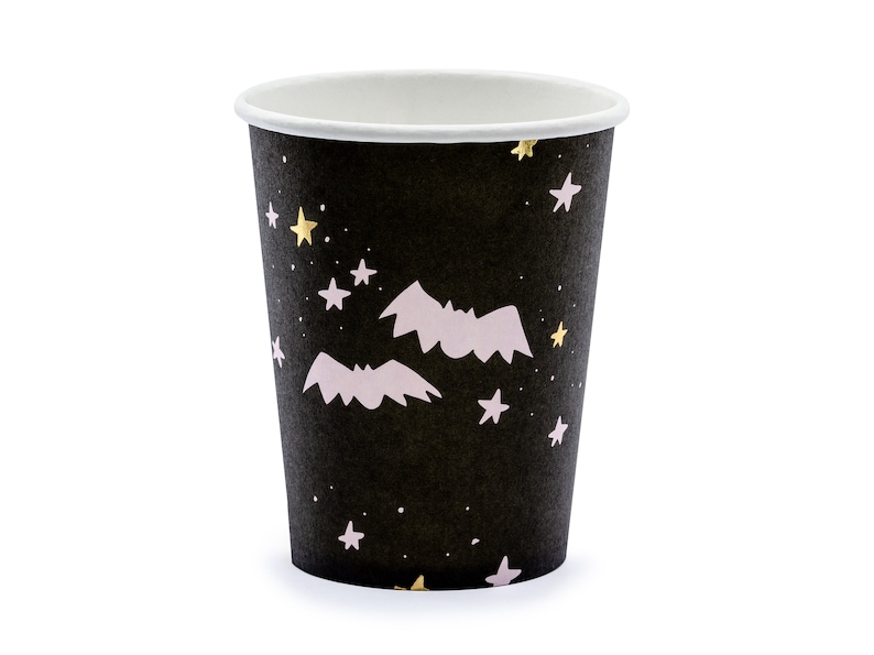 May include: A black paper cup with a white interior, decorated with a pattern of gold and white stars, and light pink bats. The cup is designed for beverages and is suitable for Halloween or themed parties.