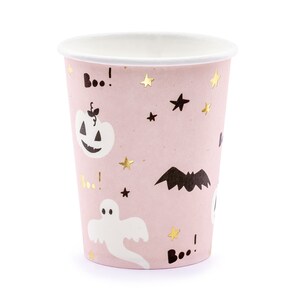 May include: A pink paper cup with a white interior, decorated with Halloween-themed illustrations. The design includes a jack-o'-lantern, a ghost, a bat, stars, and the word "Boo!" in black and gold. Perfect for Halloween parties.