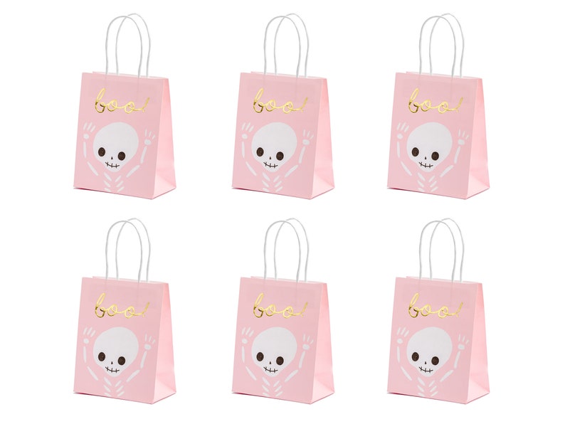 May include: Six pink paper gift bags with white handles. Each bag has a gold skeleton graphic and the word "boo!" printed on the front.