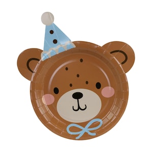 May include: A brown paper plate shaped like a teddy bear's face, decorated with a blue party hat and bow. The bear has black eyes, a black nose, and pink cheeks. Ideal for a children's birthday celebration.