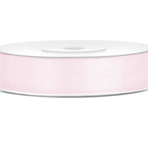 May include: A roll of pale pink satin ribbon.
