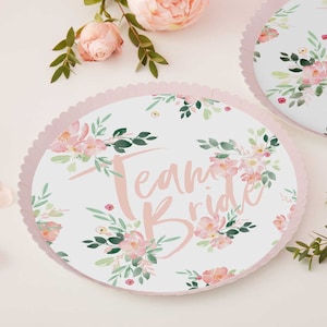 May include: Pink and white paper plates with a floral pattern and the text "Team Bride" in pink.