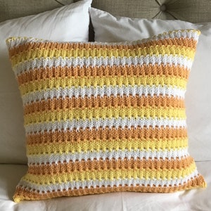Hand knitted ‘sunrise stripe’ Aran cushion