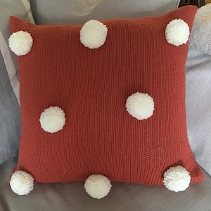 Hand knitted brick colour cotton Aran pom-pom cushion cover