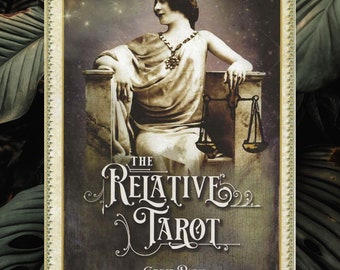 May include: A vintage-style tarot card with a woman wearing a crown and holding a scale. The card is titled "The Relative Tarot" by Carrie Paris.
