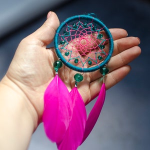 Magenta pink with emerald green tiny dream catcher car accessory.