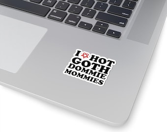 May include: A white sticker with black text that reads "I ♥ HOT GOTH DOMMIE MOMMIES". The heart has a red anarchy symbol inside.