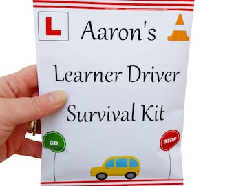 May include: A white and red striped bag with the text "Aaron's Learner Driver Survival Kit" and a yellow car graphic. The bag has a red L sign, a yellow traffic cone, a green GO sign, and a red STOP sign.