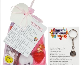 May include: A pink organza bag filled with small gifts and a card that reads "Birthday Survival Kit - Birthday You Will Need". The bag also includes a small puzzle piece, a red heart, and a small white candle. A separate card with a colorful "Happy Birthday!" design and a key chain with a birthday cake charm is also included. The charm has the text "On this keyring you will find a Special Wish Charm to help make your Birthday Wish come true!"