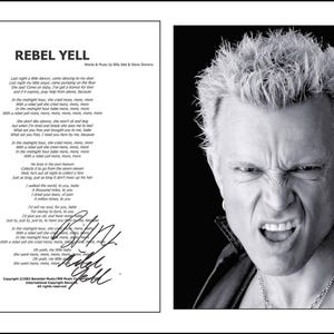 May include: A black and white print featuring the lyrics to the song Rebel Yell by Billy Idol and Steve Stevens, including a signature, alongside a portrait of Billy Idol with spiky hair and an intense expression, all within a white border.