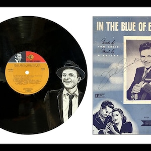 May include: A black vinyl record with a portrait of Frank Sinatra on the label. The record is titled "Frank Sinatra's Greatest Hits". The image also shows a sheet music cover for the song "In the Blue of Evening" by Frank Sinatra.