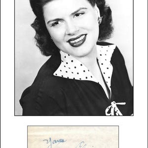 May include: A monochrome portrait of a woman with dark, styled hair, wearing a black top with a white polka dot collar. The image includes a handwritten note that reads "Yours, Patsy Cline".