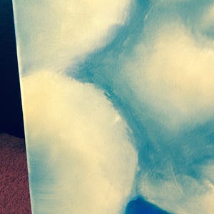 May include: Abstract painting with a blue and white color scheme. The painting features a large, abstract shape in the center, with smaller shapes surrounding it. The colors are blended together to create a soft, ethereal effect.