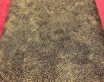 May include: A close-up of a textured fabric with a repeating pattern of small black circles and lines on a yellow background.