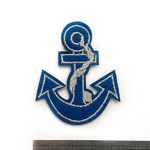May include: Blue anchor iron-on patch with silver embroidery. The patch is approximately 2.5 cm wide.