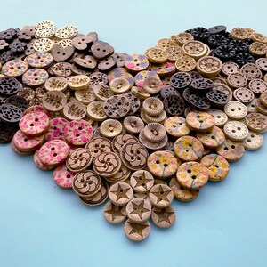 May include: A heart-shaped arrangement of wooden buttons in various colours and patterns, including floral, geometric, and abstract designs.