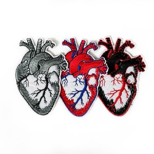 May include: Three embroidered iron-on patches of anatomical hearts in red, black, and grey.