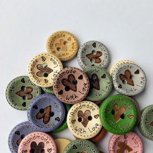 Mixed selection of pastel and earthy tone buttons for sewing baby cardigans.