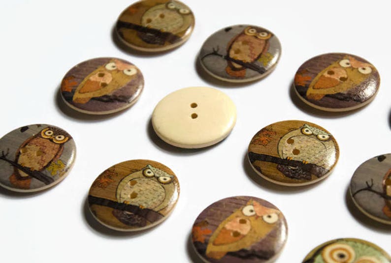 Cute owl design buttons which are printed on the front and have a plain back.