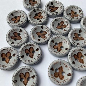 Decorative wooden buttons for scrapbooking and embellishing greeting cards. colour is blue grey
