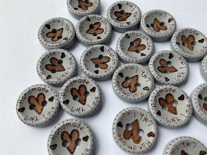 Decorative wooden buttons for scrapbooking and embellishing greeting cards. colour is blue grey