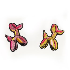 Pink and yellow balloon dog badge