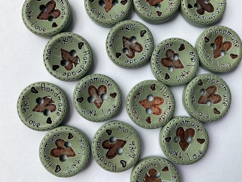 Heart cut-out wooden buttons to embellish scarves and hats. beautiful pastel sage green wooden buttons. 15mm in size with 2 holes